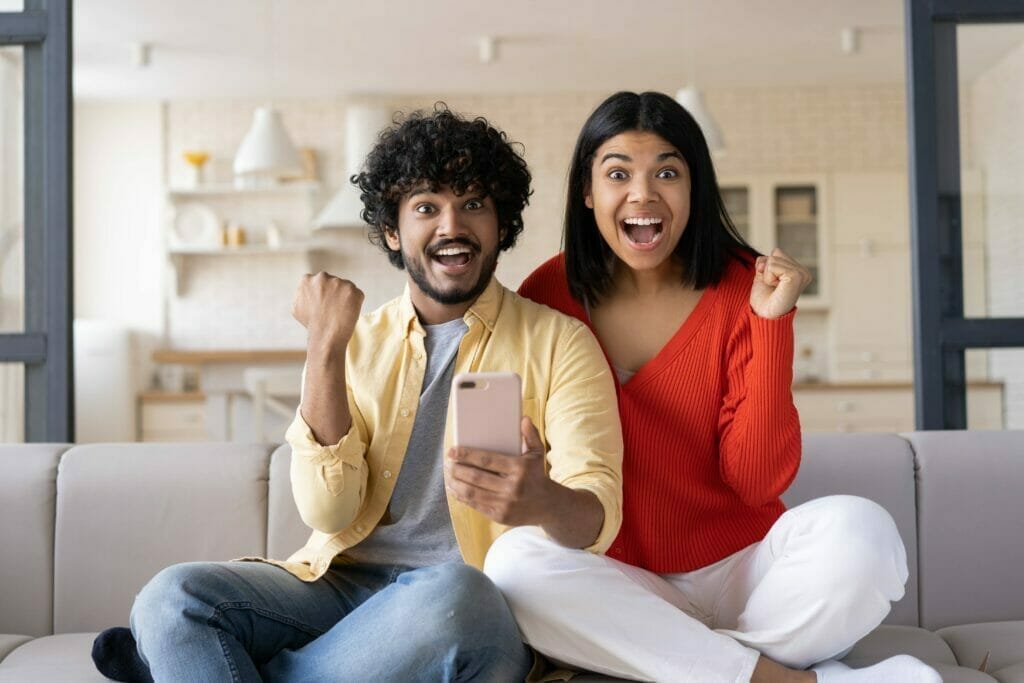 excited friends using smartphone shopping online with sales emotional couple win online lottery