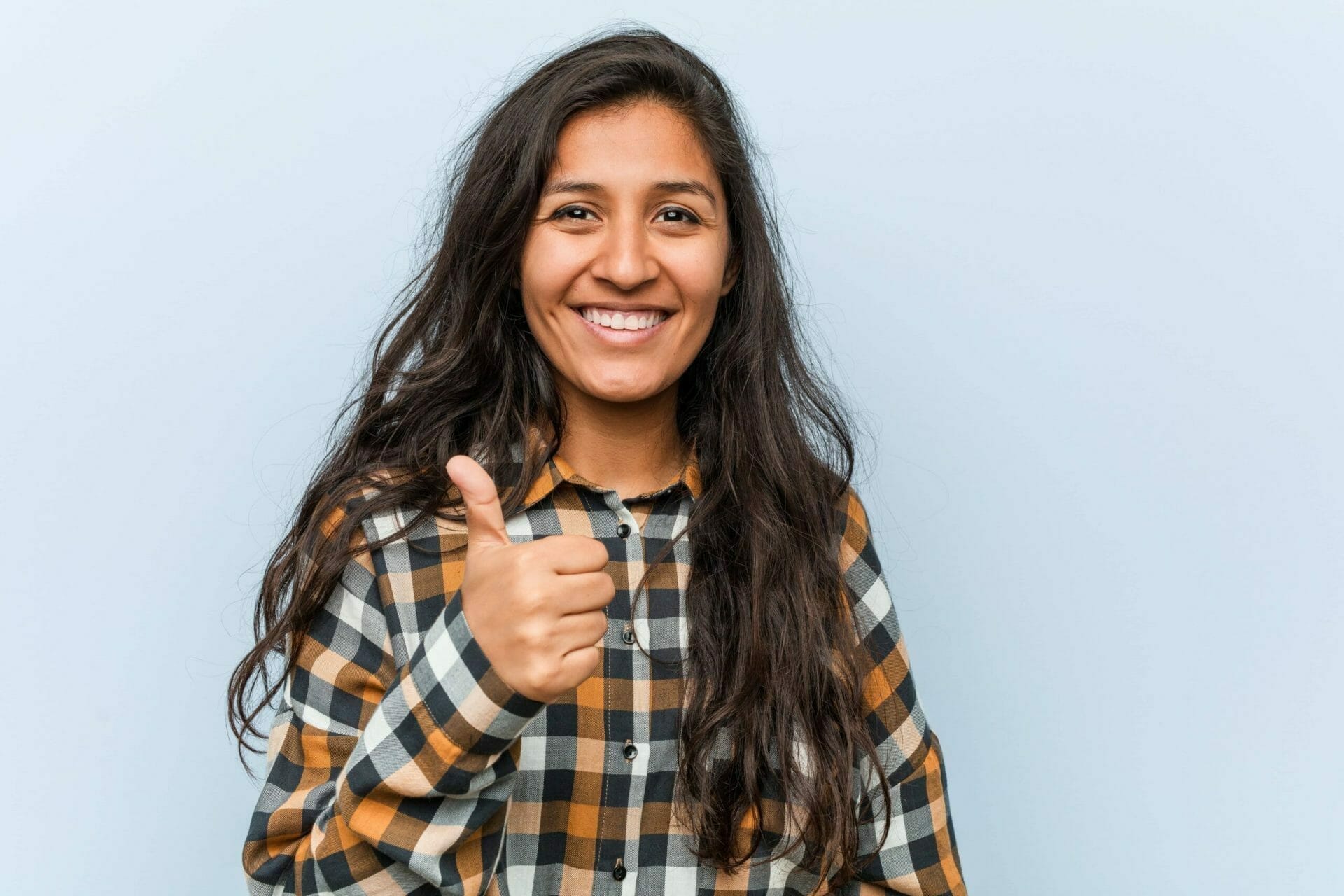 young cool indian woman smiling raising thumb up min 1 scaled